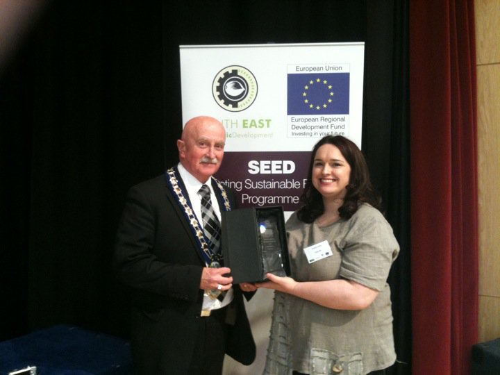 Maebh Collins at a professional event with another attendee
